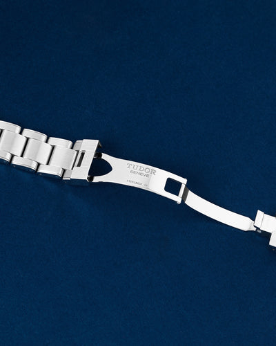 Detailed view of the open folding deployment buckle mechanism on a stainless steel Tudor Black Bay rivet bracelet
