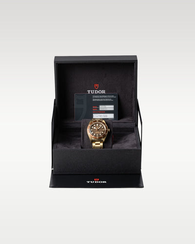 The complete retail collector presentation layout showing the bronze Tudor Black Bay Fifty Eight M79012M 0001 timepiece resting safely inside its inner black luxury display box at Grand Caliber in Dallas, Texas