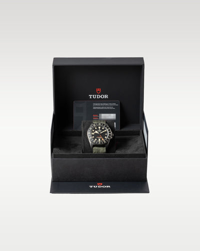 An open black Tudor luxury watch presentation box displaying the Pelagos FXD GMT securely nested inside