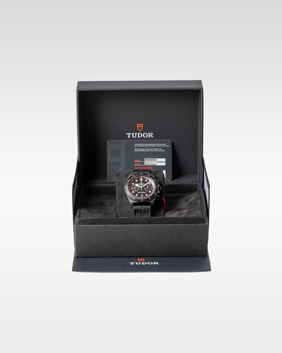 open black textured Tudor presentation watch box securely displaying a carbon composite Pelagos FXD Chrono watch inside