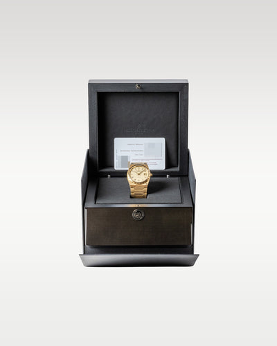 open dark grey textured Vacheron Constantin luxury presentation box displaying a solid 18k yellow gold Historiques 222 watch