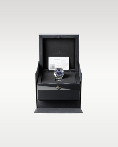 open dark grey textured Vacheron Constantin luxury watch box safely displaying a blue dial Overseas 4500V watch inside