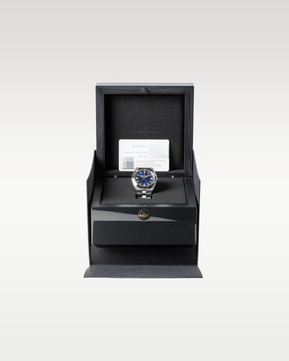 open dark grey textured Vacheron Constantin luxury watch box safely displaying a blue dial Overseas 4500V watch inside
