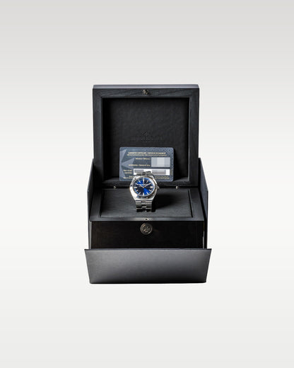 open dark grey textured Vacheron Constantin luxury watch box displaying a blue dial Overseas 4500V watch inside