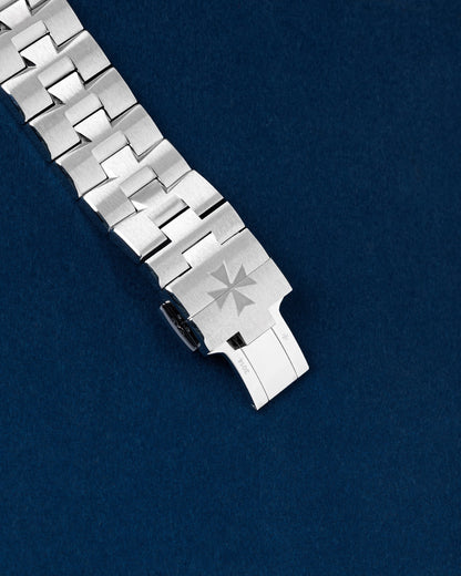 exterior view of a closed stainless steel Vacheron Constantin Overseas bracelet clasp forming a Maltese Cross