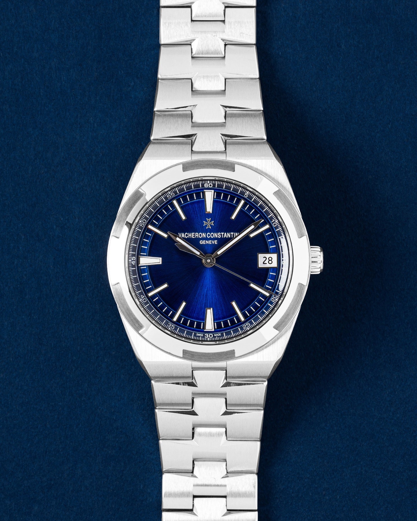 Vacheron Constantin Overseas watch featuring a translucent blue lacquered dial, signature Maltese Cross steel bezel and integrated bracelet