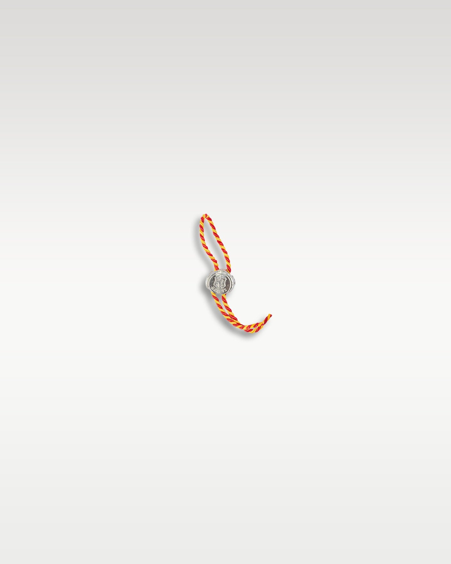official white decorative watch hangtag with a bright orange string representing the Poinçon de Genève hallmark