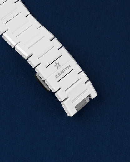 Close-up view of the closed integrated white ceramic bracelet deployment clasp with the Zenith star logo