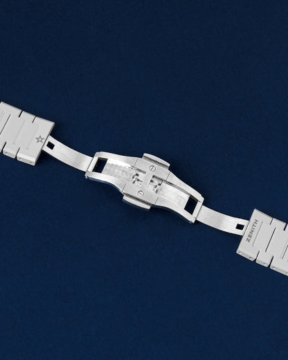 Detailed view of the open double-folding deployment buckle clasp on a white ceramic Zenith Defy Skyline watch bracelet