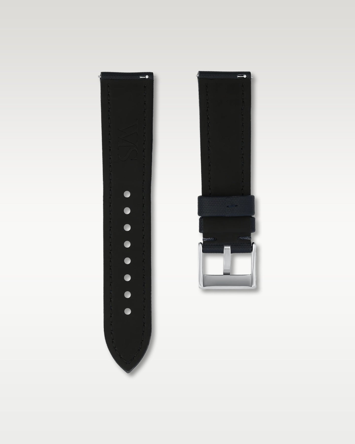 Reverse side view of a 22mm midnight blue sailcloth watch strap showing integrated quick-release spring levers, dark lining, and engraved buckle