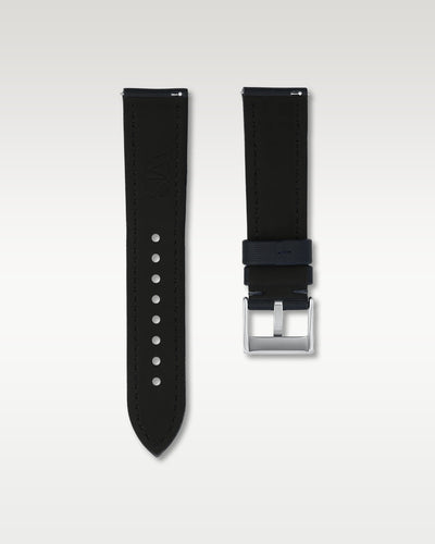 Reverse side view of a 22mm midnight blue sailcloth watch strap showing integrated quick-release spring levers, dark lining, and engraved buckle