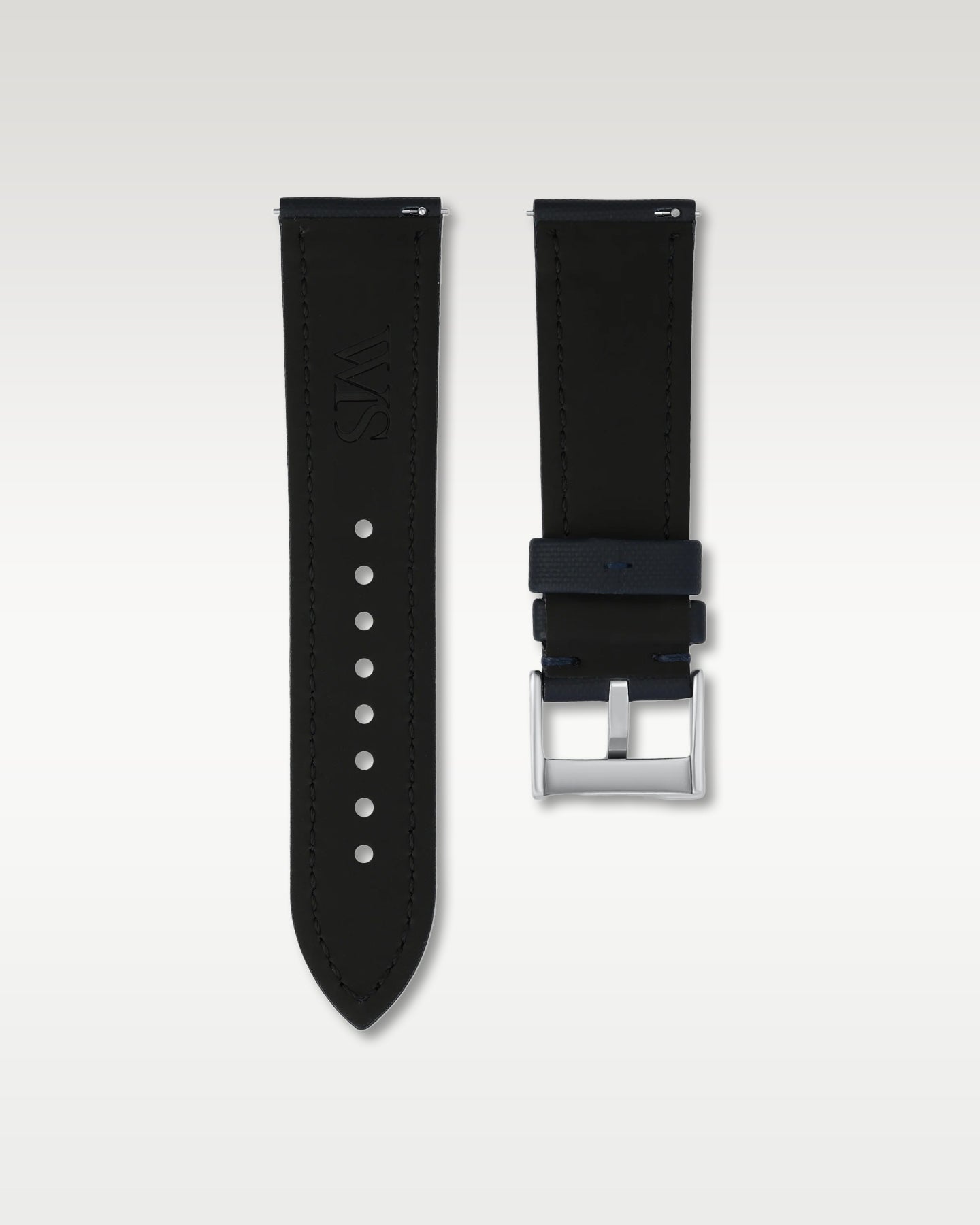 Reverse side view of a 24mm midnight blue sailcloth watch strap showing integrated quick-release spring levers, dark lining, and engraved buckle