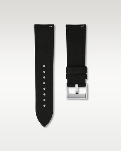Reverse side view of a 24mm black sailcloth watch strap showing integrated quick-release spring levers, dark lining, and engraved WIS buckle